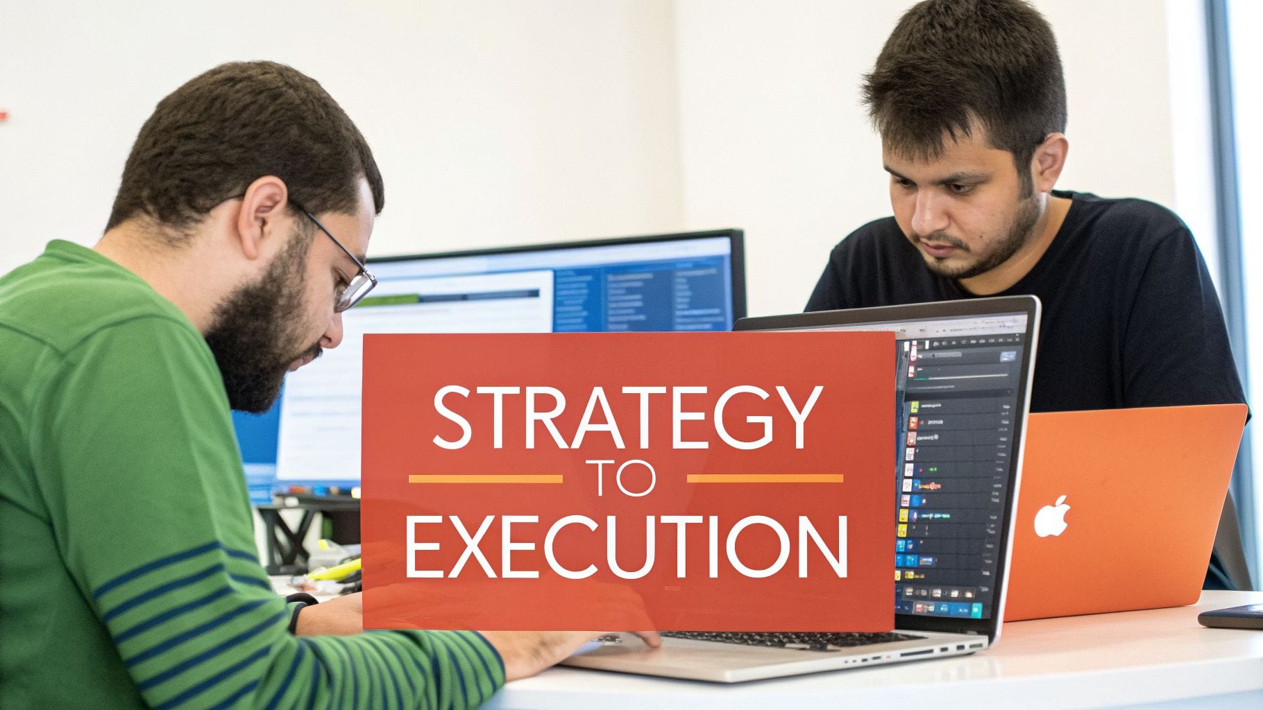 Two men deeply focused on their laptops in an office with a 'Strategy to Execution' overlay.